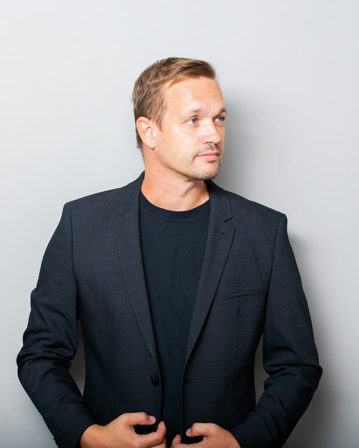 Dr. Marc Halder, photographed against a white studio wall.