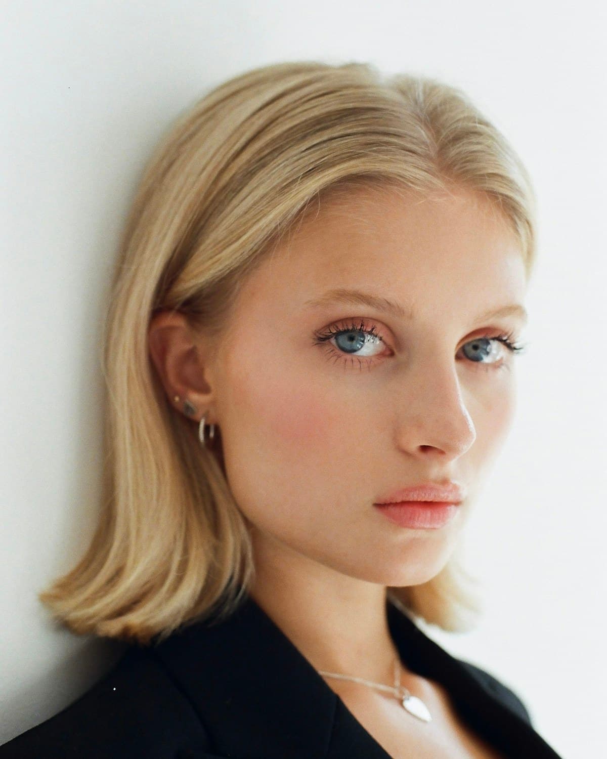 Dr. Nadia Kern, photographed in daylight against a neutral wall.