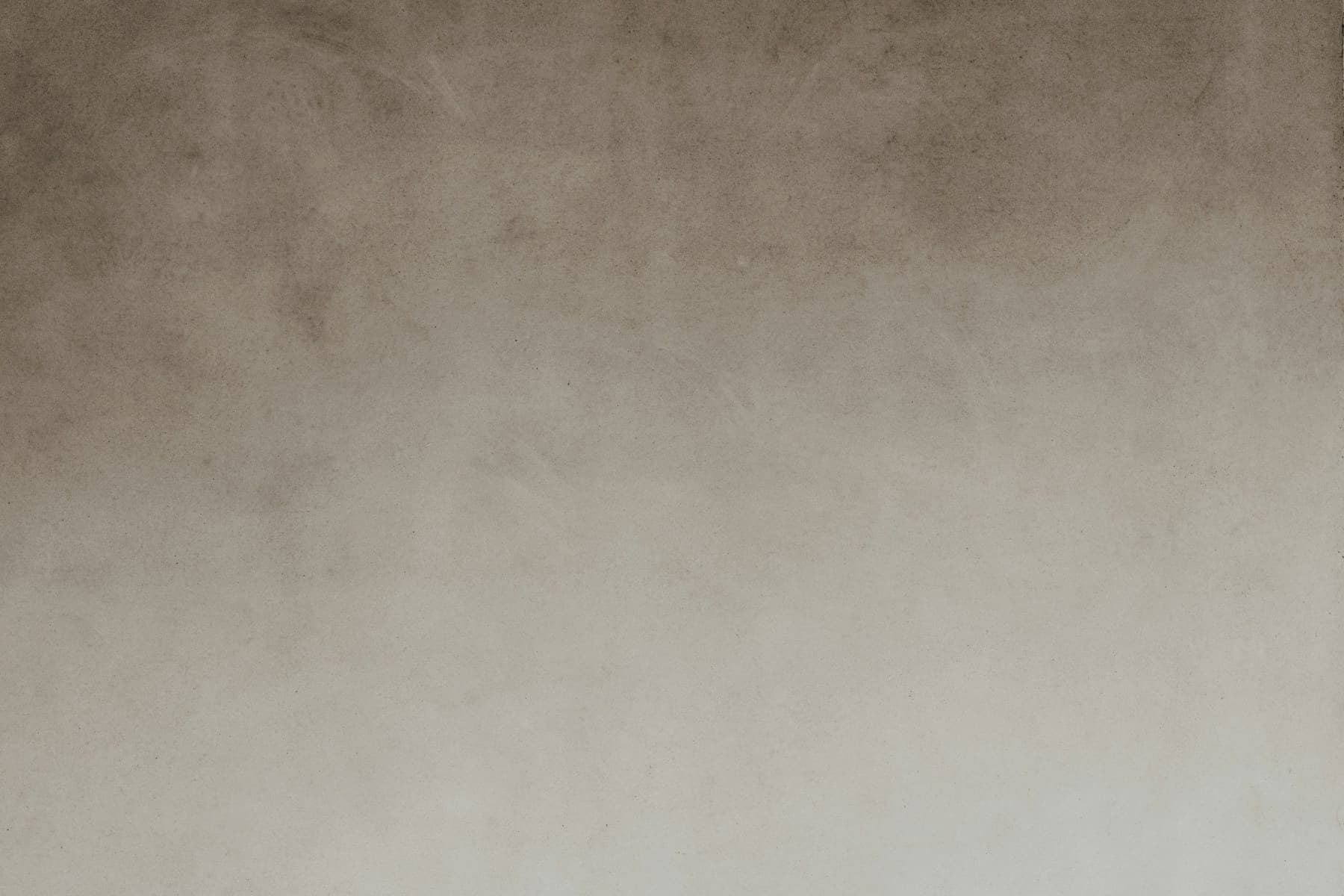 Geometric light falling across a plaster wall.
