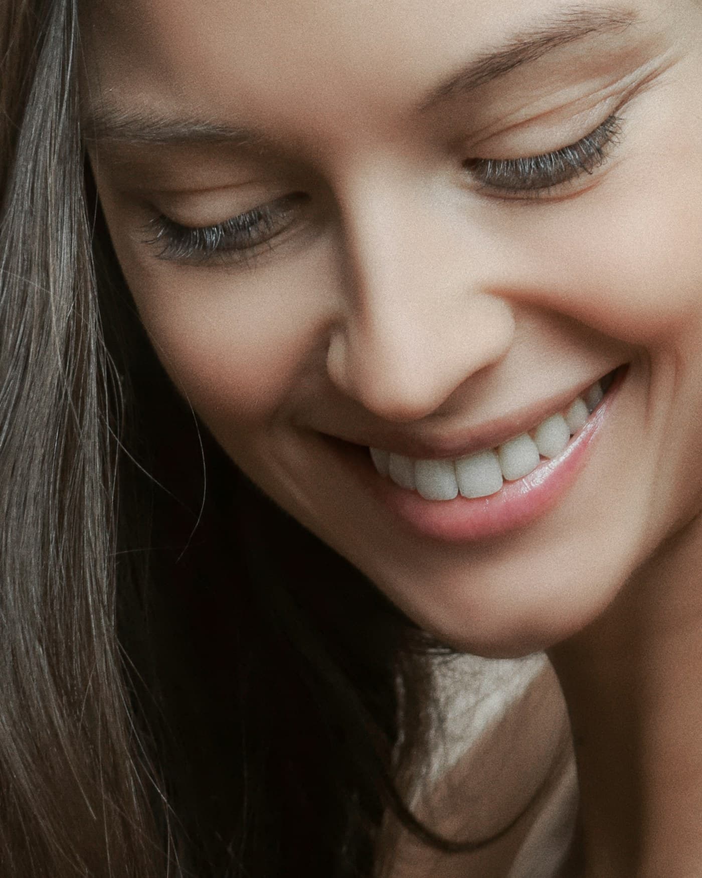 A patient smiling in daylight, photographed from a short distance.